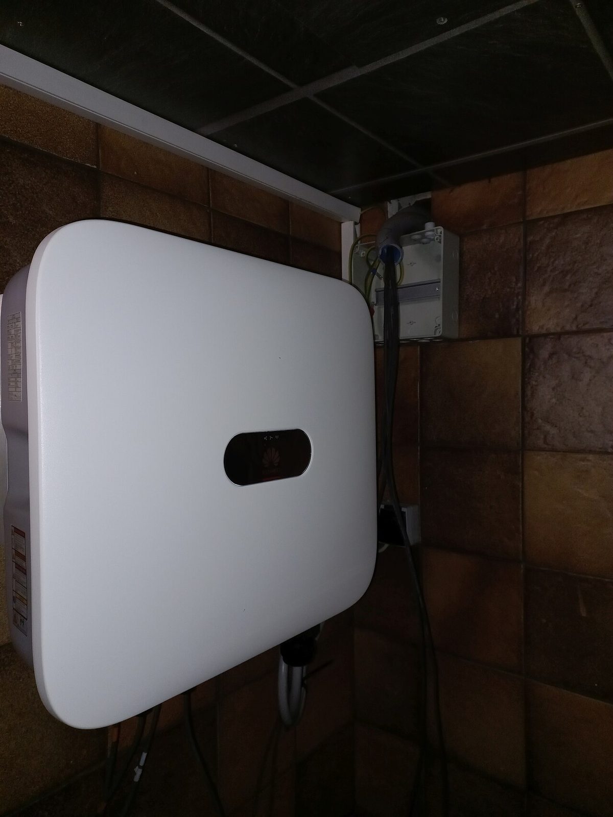 A white Huawei SUN2000-17KTL-M2 three-phase inverter, a larger sibling of the L1 and M1 models reviewed here, wall-mounted indoors in Feldkirch, Austria